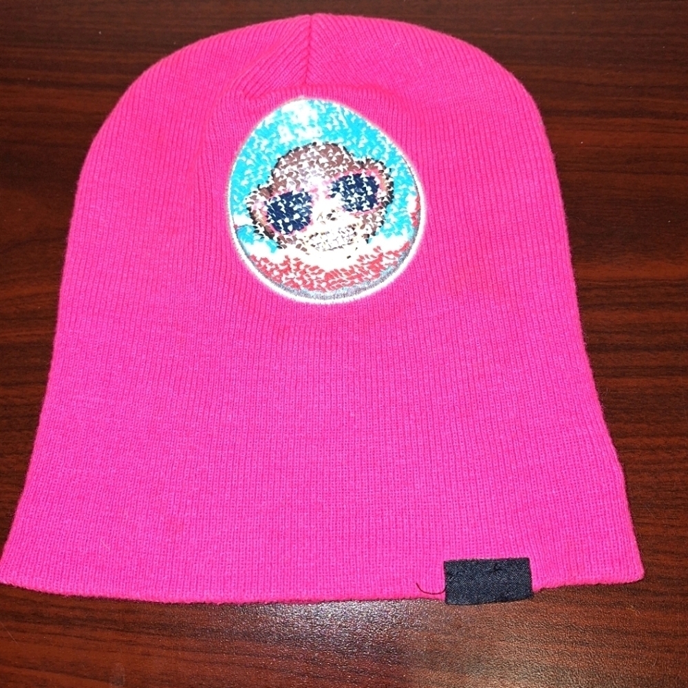 An Emoji beanie in a one size fits most. Hot pink with monkey image.